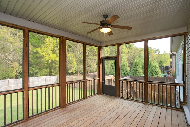 unfurnished sunroom featuring ceiling fan