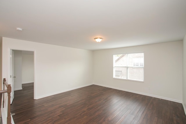 unfurnished room with dark hardwood / wood-style floors