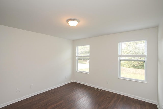 empty room with dark hardwood / wood-style floors