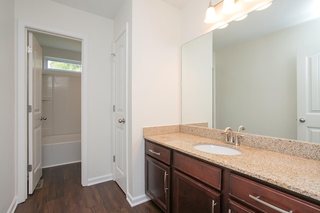 bathroom featuring vanity, plus walk in shower, and hardwood / wood-style floors