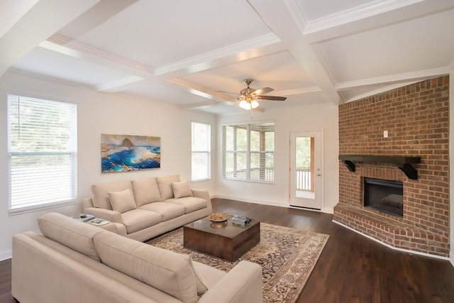 living room with dark wood-type flooring, a brick fireplace, ceiling fan, and a healthy amount of sunlight