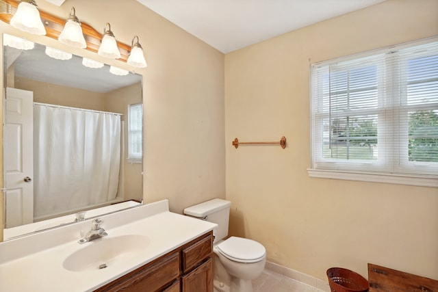 bathroom with tile patterned flooring, toilet, and vanity