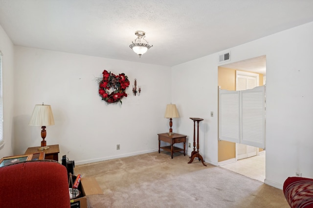 living area featuring light colored carpet