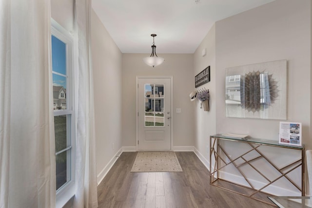 entryway featuring dark wood finished floors and baseboards