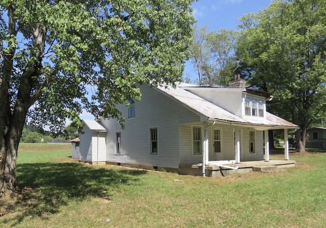 back of house with a lawn