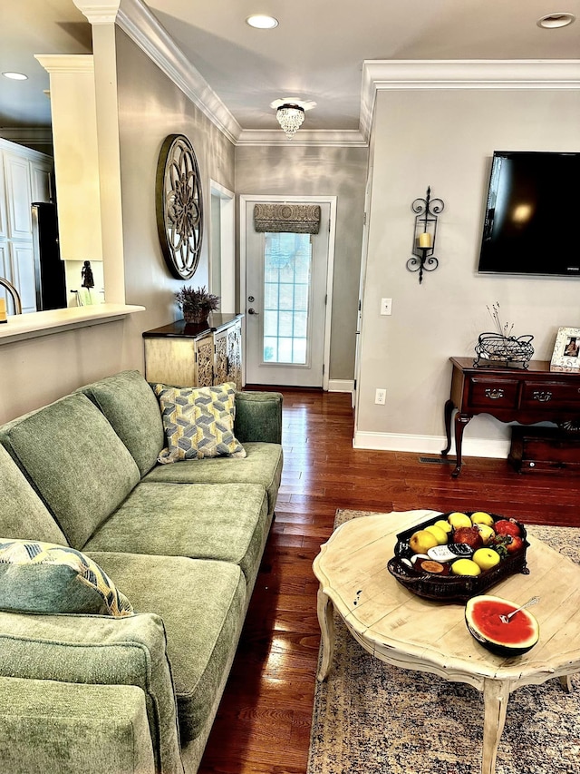 living room with dark wood-type flooring and ornamental molding