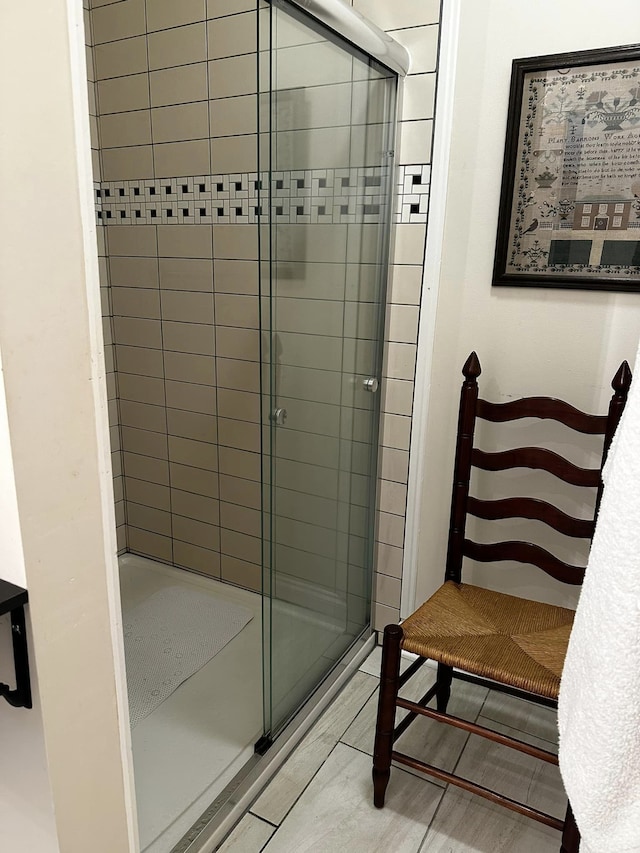 bathroom with tile patterned flooring and a shower with door