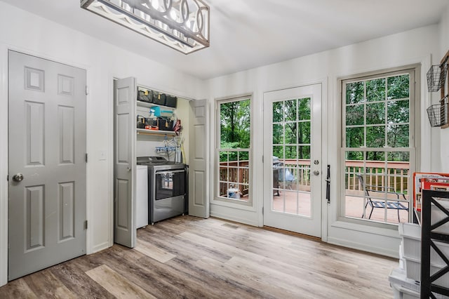 entryway featuring a wealth of natural light, light hardwood / wood-style flooring, and independent washer and dryer