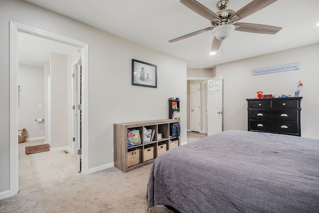 bedroom featuring ceiling fan, light carpet, and ensuite bathroom