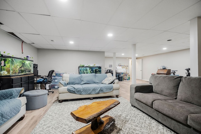 living room featuring hardwood / wood-style flooring and a paneled ceiling