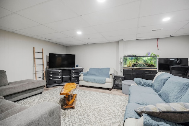 living room featuring a paneled ceiling