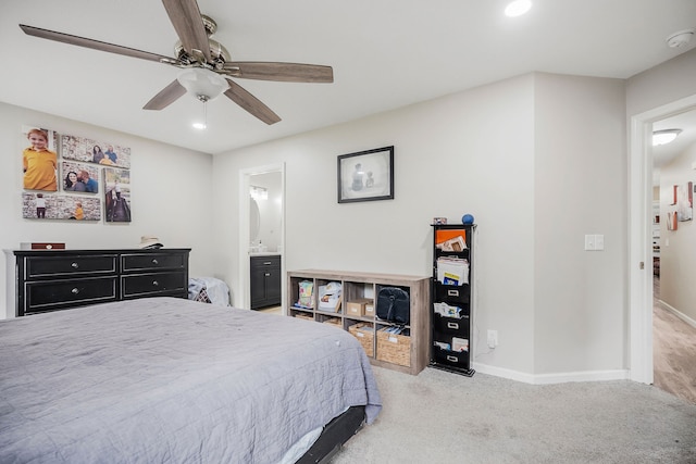 carpeted bedroom featuring ceiling fan and ensuite bath