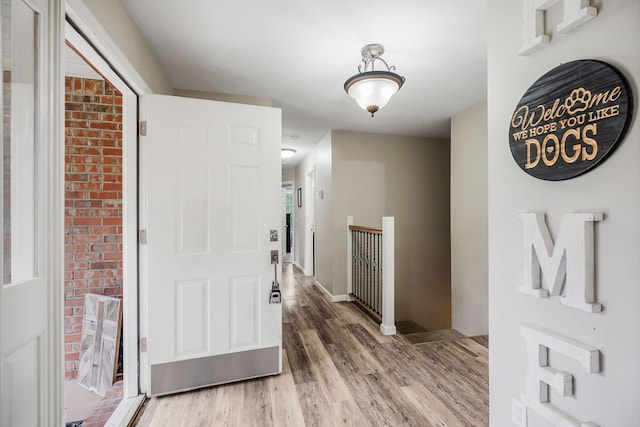 corridor with hardwood / wood-style flooring