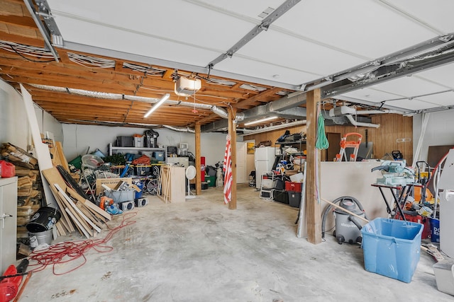 garage featuring a garage door opener and white fridge