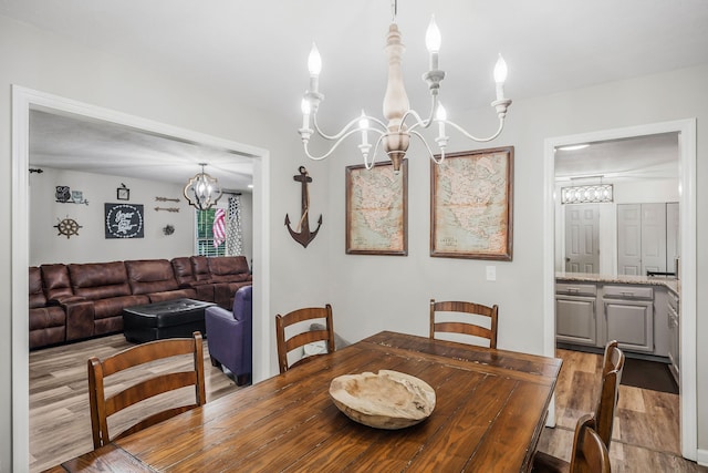 dining area featuring a chandelier and hardwood / wood-style flooring