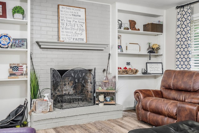 living room with light hardwood / wood-style flooring and a fireplace