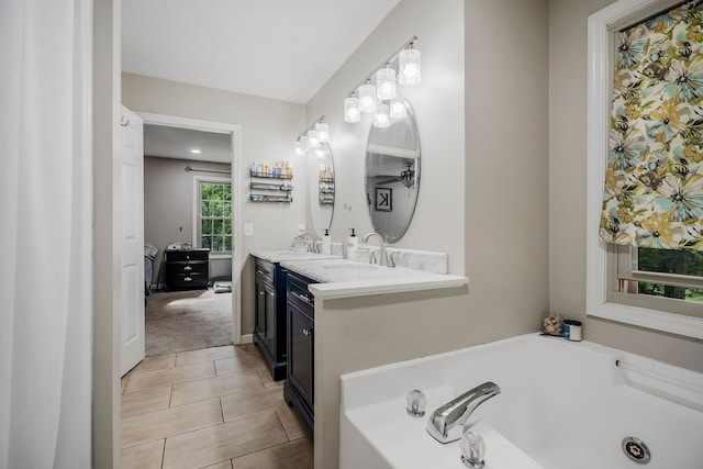 bathroom featuring tile patterned floors, dual vanity, and a tub to relax in