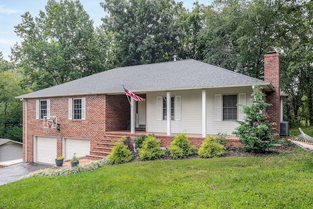 view of front of home featuring a garage, central AC, and a front yard