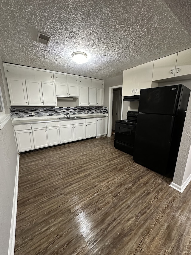 kitchen with dark hardwood / wood-style flooring, tasteful backsplash, white cabinetry, a textured ceiling, and black appliances