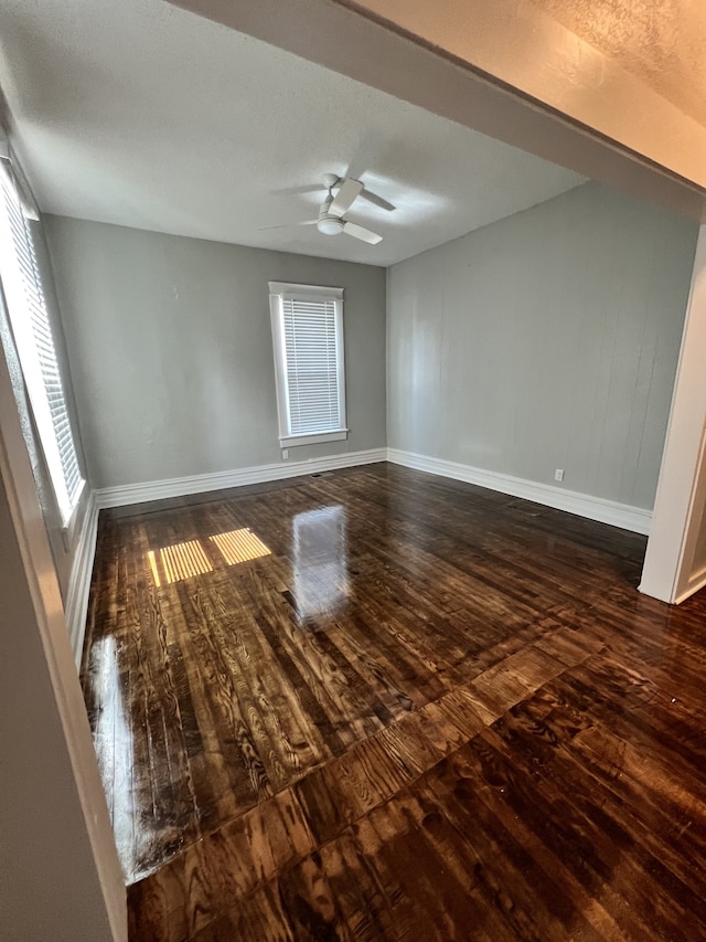 empty room featuring ceiling fan and dark hardwood / wood-style floors