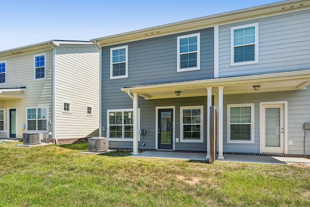 back of property with a yard and cooling unit