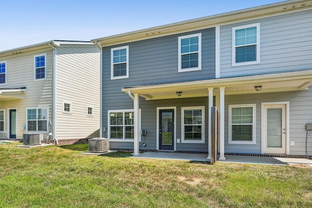 back of house with a yard, a patio area, and central AC