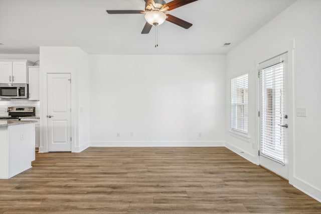 interior space featuring ceiling fan and light hardwood / wood-style flooring