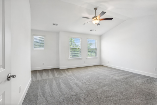 carpeted spare room with ceiling fan and lofted ceiling