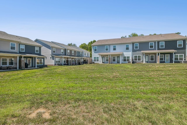 rear view of property featuring a yard