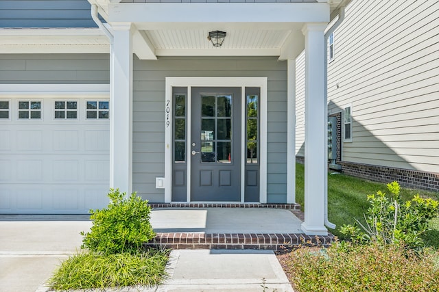 view of exterior entry featuring a garage