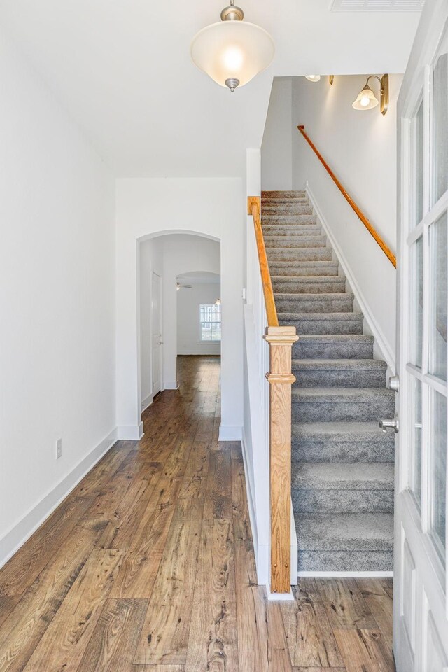 staircase with wood-type flooring