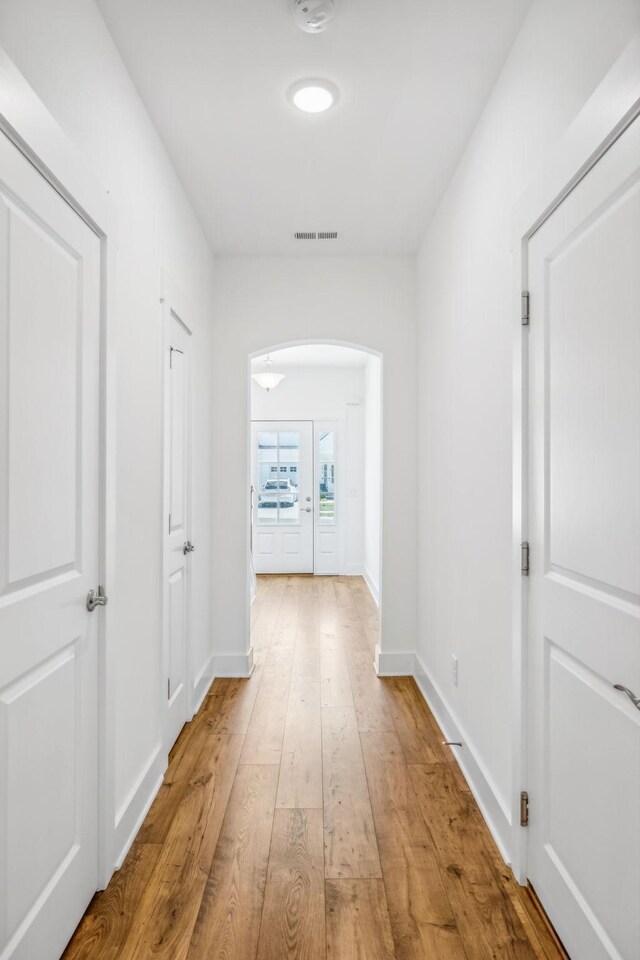 corridor featuring light hardwood / wood-style floors