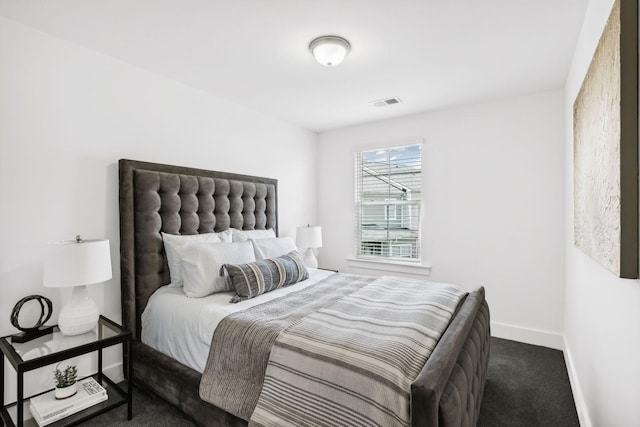 bedroom with dark colored carpet