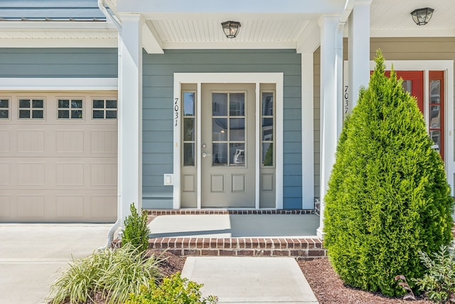 entrance to property featuring a garage and a porch