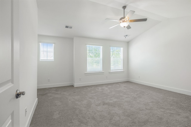 empty room featuring carpet floors, ceiling fan, and lofted ceiling