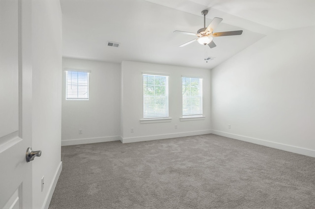 spare room featuring ceiling fan, vaulted ceiling, and light colored carpet