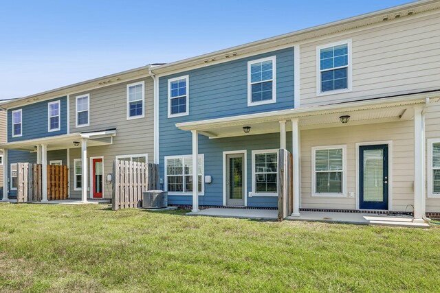 exterior space with central AC and a lawn