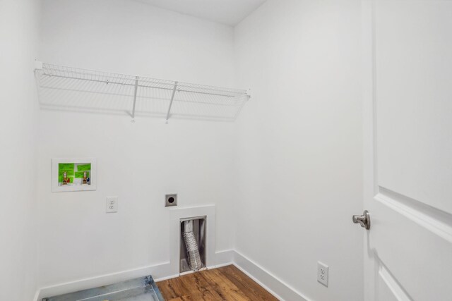 clothes washing area with hookup for an electric dryer, hookup for a washing machine, and hardwood / wood-style floors