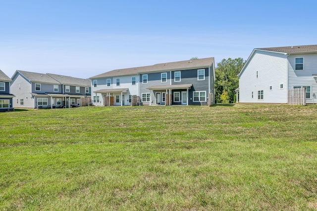 rear view of property with a yard