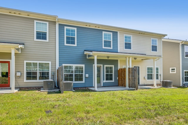 rear view of house with a patio area, a yard, and central air condition unit