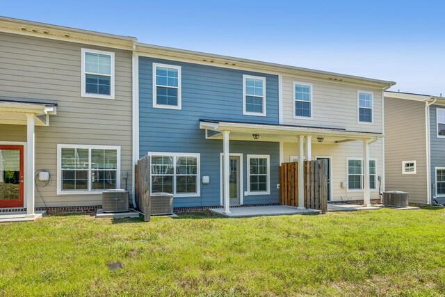 back of property featuring a lawn and central AC unit