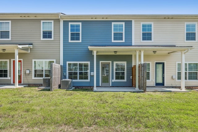 view of front of house with a front yard and cooling unit