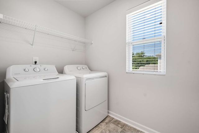 laundry room featuring washing machine and dryer and light tile patterned floors