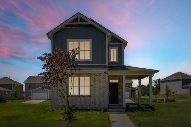 view of front of house with a yard and a garage