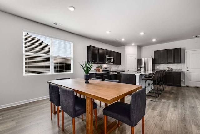 dining space featuring light hardwood / wood-style floors