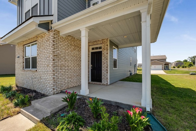 entrance to property featuring a garage and a yard