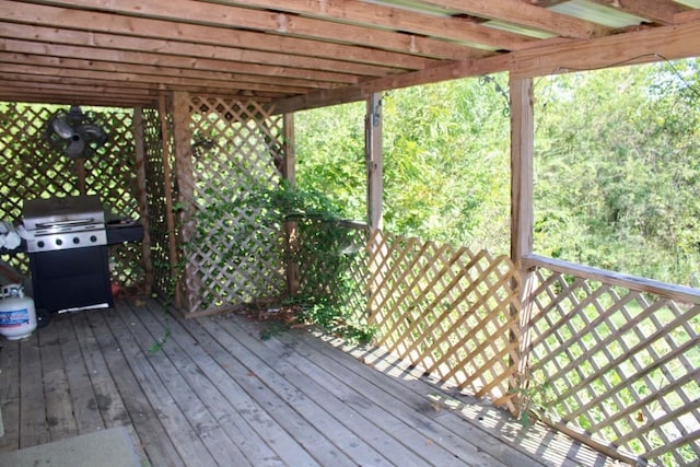 wooden deck with a pergola and a grill