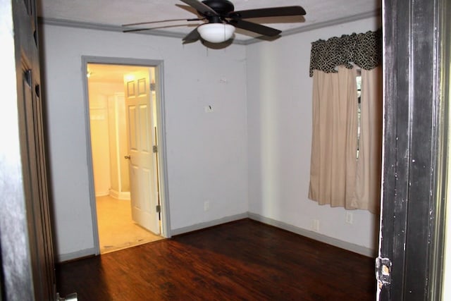 empty room with ceiling fan and dark hardwood / wood-style floors