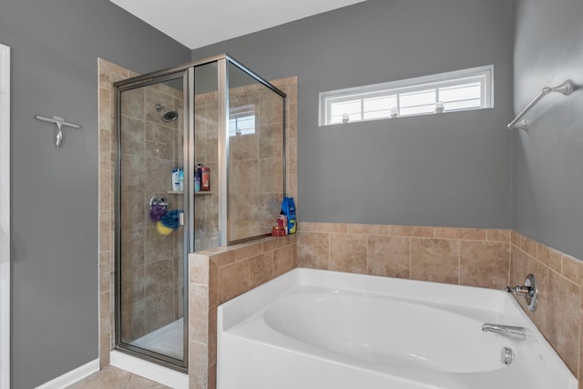 bathroom with tile patterned flooring and separate shower and tub