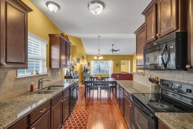 kitchen featuring sink, hardwood / wood-style flooring, tasteful backsplash, ceiling fan, and black appliances